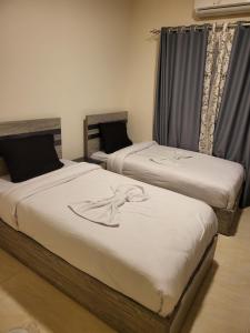two twin beds in a room withskirts at Luxury Aqua Tropical Resort Next To Al Gouna 4 0 1 in Hurghada +12 photos