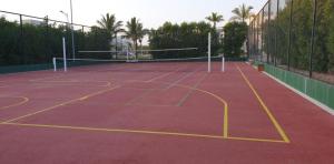 a tennis court with yellow lines on the court at Royal Hawana Apartment salalah in Salalah