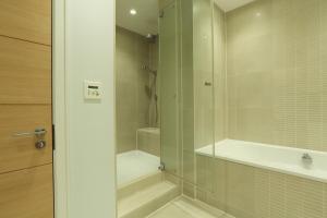 a bathroom with a shower with a glass door at 9 Dart Marina in Dartmouth +23 photos