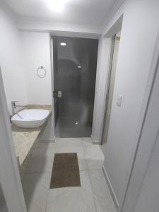 a bathroom with a shower and a sink and a toilet at Iguaçu Hospedagem in Foz do Iguaçu