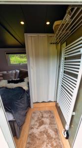 a small room with a bed and a window at Golden Circle Truck Hotel in Selfoss