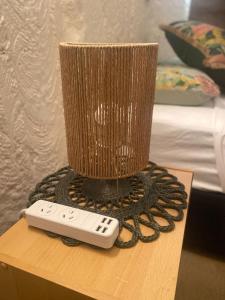 a remote control sitting on a table with a vase at Ali's Underground Home in Coober Pedy