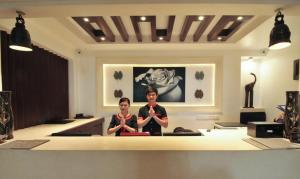 two people standing at a counter in a room at La Rose Suites in Phnom Penh +124 photos
