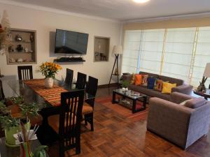 a living room with a couch and a table at Uli´s house in Lima