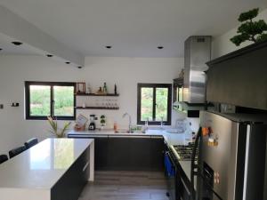 a kitchen with a sink and a refrigerator at CASA DE LEON para tu familia in Huehuetenango