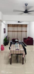 a living room with a table and a couch at D'Zara Homestay in Sepang
