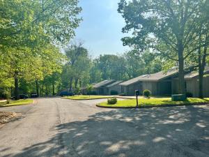 an empty street in a residential neighborhood with houses at Greens One Vacation Home 36 in Bella Vista