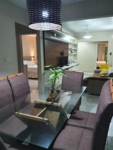 a living room with a glass table with a plant on it at Casa 3quartos rota Maragogi Carneiros in São José da Coroa Grande