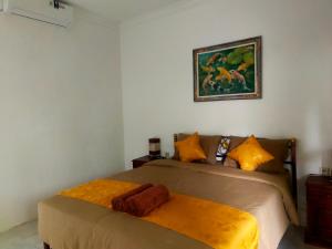 The Rahayu Cottage客房内的一张或多张床位