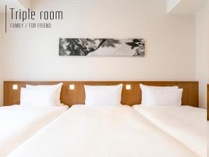Postel nebo postele na pokoji v ubytování Hotel Gracery Naha