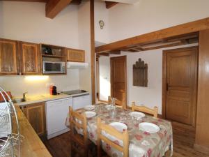 a kitchen with a table with chairs and a kitchen with a tableablish at Appartement Aussois, 3 pièces, 6 personnes - FR-1-508-271 in Aussois