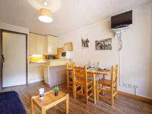 a kitchen and dining room with a table and chairs at Studio pour 4 à Saint-Lary, proche centre et télécabine - FR-1-296-413 in Saint-Lary-Soulan +16 photos