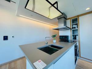 a kitchen with a sink and a counter top at Manhattan Loft Gardens, Stratford E20 in London