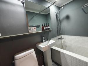 a bathroom with a toilet and a sink and a shower at Daljee Guesthouse in Seoul