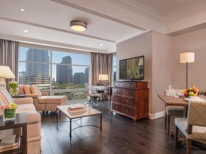 
a living room filled with furniture and a tv at Discovery Primea in Manila
