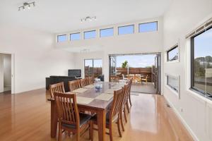 a dining room with a long table and chairs at Bayside Haven in Portarlington