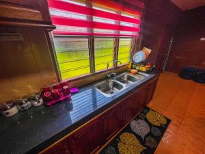 a kitchen with a sink and a window at Nail Guest House Kuala Besut in Kampong Nail +13 photos