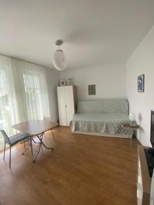 a bedroom with a bed and a table in it at Belvedere Apartments in Byala