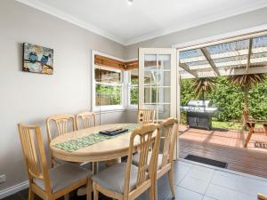 a dining room with a table and chairs at Resarf Retreat in Portarlington