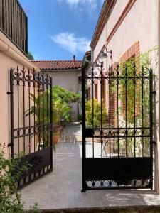 une porte en fer menant à une maison avec une cour dans l'établissement La bulle de Gaston, à Toulouse