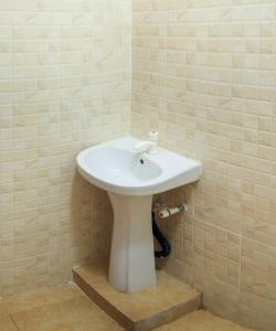 a bathroom with a white sink in a room at Oceanic Homes in Mombasa