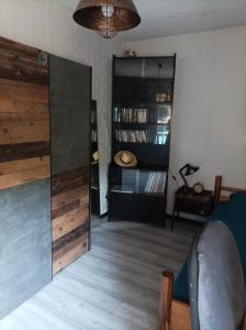 a living room with wooden floors and a large mirror at Chez Fanny Chambres d'hôtes in Fos-sur-Mer