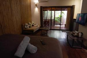 um quarto de hotel com um urso de peluche na cama em Fisheye The Rooms - Family room em El Nido