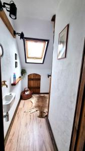 a bathroom with a sink and a mirror and a floor at Přemyslovský dvůr in Slezské Pavlovice