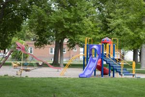 a playground with a slide in a park at Monument Inn & Suites in Gering