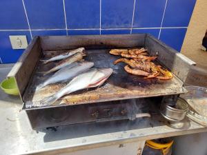 a bunch of fish are cooking on a grill at ROCADE DE COLLIOURE appt T4 avec grande terrasse et garage in Collioure