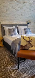 a bedroom with a bed with a deer on it at Krokus Park Residence in Kościelisko