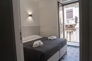 a bedroom with a bed with towels on it at Zagara e Lumia in Catania