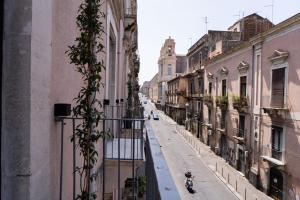 a view of an empty street between buildings at Zagara e Lumia in Catania