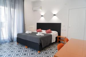 a bedroom with a bed with red pillows at Zagara e Lumia in Catania +37 photos