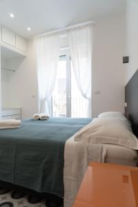 a bedroom with a large bed and a window at Zagara e Lumia in Catania