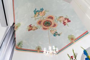 a ceiling with disney paintings on it at Zagara e Lumia in Catania