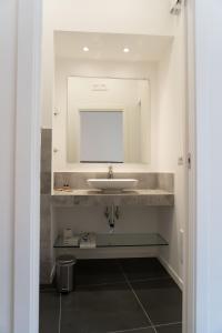 a bathroom with a sink and a mirror at Zagara e Lumia in Catania