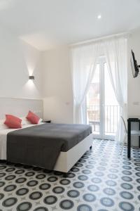 a bedroom with a bed and a large window at Zagara e Lumia in Catania