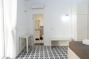 a bedroom with a black and white tiled floor at Zagara e Lumia in Catania