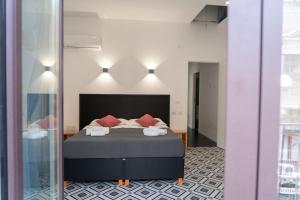 a bedroom with a bed and a mirror at Zagara e Lumia in Catania
