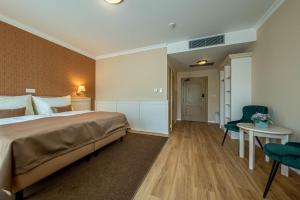 Postel nebo postele na pokoji v ubytování Wellness Hotel Pivovar Monopol