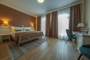 Postel nebo postele na pokoji v ubytování Wellness Hotel Pivovar Monopol