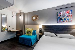 弗盧瓦拉克的住宿－Greet Hotel Bordeaux Floirac Arena，一间卧室配有一张床和一张蓝色椅子