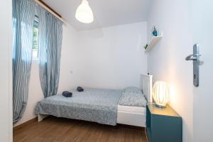 Postel nebo postele na pokoji v ubytování Apartment Sunset Rovanjska
