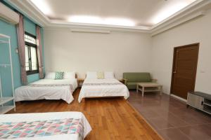 Postel nebo postele na pokoji v ubytování 小葉園民宿Little Ya B&B