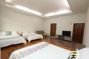 Postel nebo postele na pokoji v ubytování 小葉園民宿Little Ya B&B
