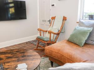 a living room with two chairs and a couch at Millgate House in Conwy
