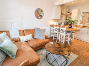 a living room with a couch and a table at Millgate House in Conwy