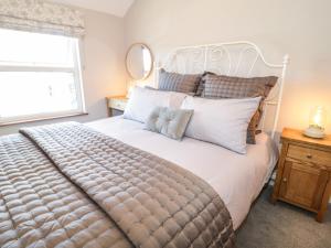 a bedroom with a large bed and a window at Millgate House in Conwy