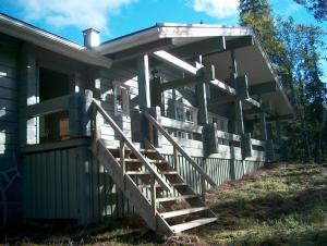a house with a staircase leading up to a porch at Vuosselin Kruunu in Ruka